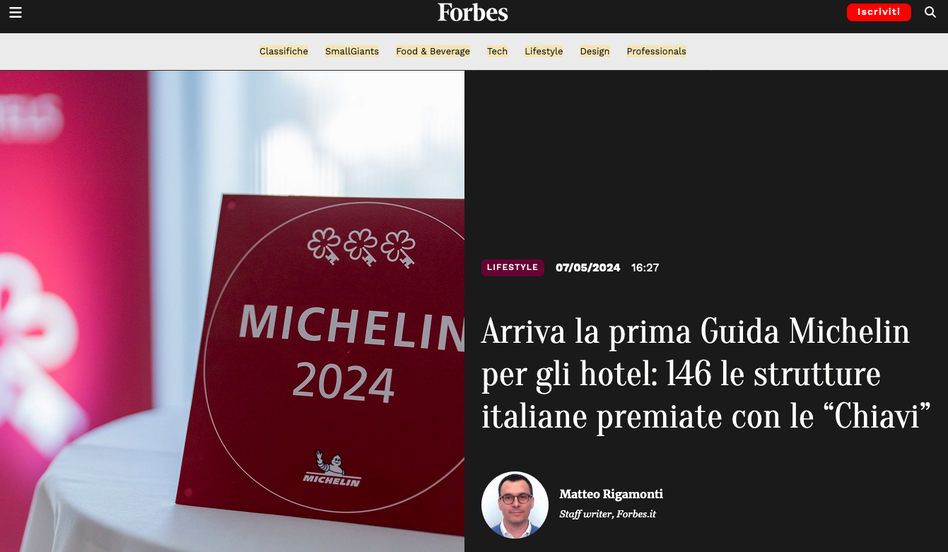 Forbes article about the Michelin Guide for hotels, featuring a red sign with three key icons and the text 
