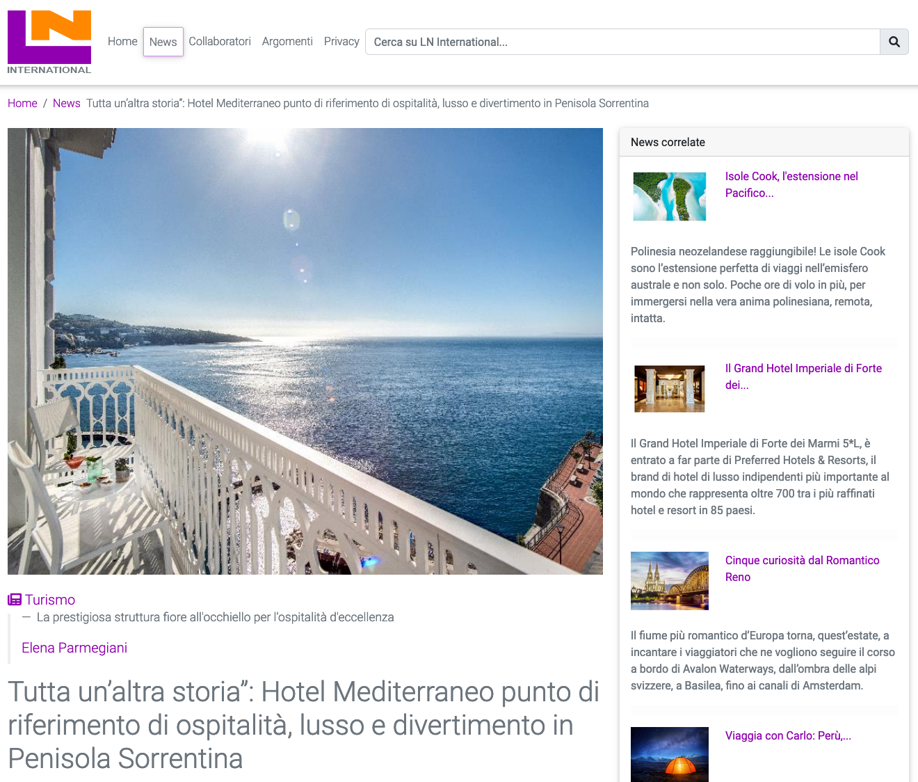 A sunny balcony overlooking the sea and rocky coastline on a bright day.