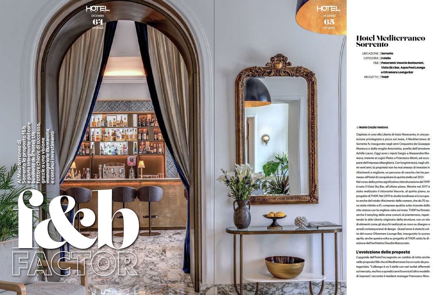 A grand arched doorway with draped curtains opens to a bar, adjacent to a decorative mirror and console table in a lobby.