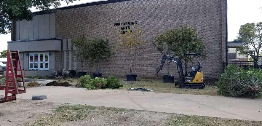 A large brick building with a ladder in front of it.