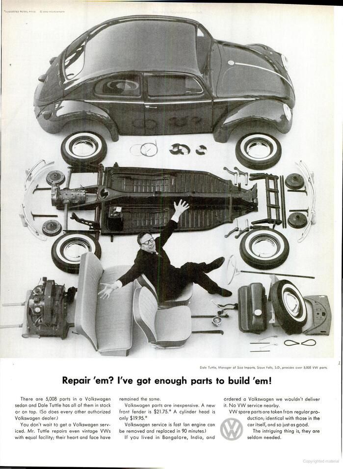 A black and white photo of a man laying on top of a volkswagen beetle.