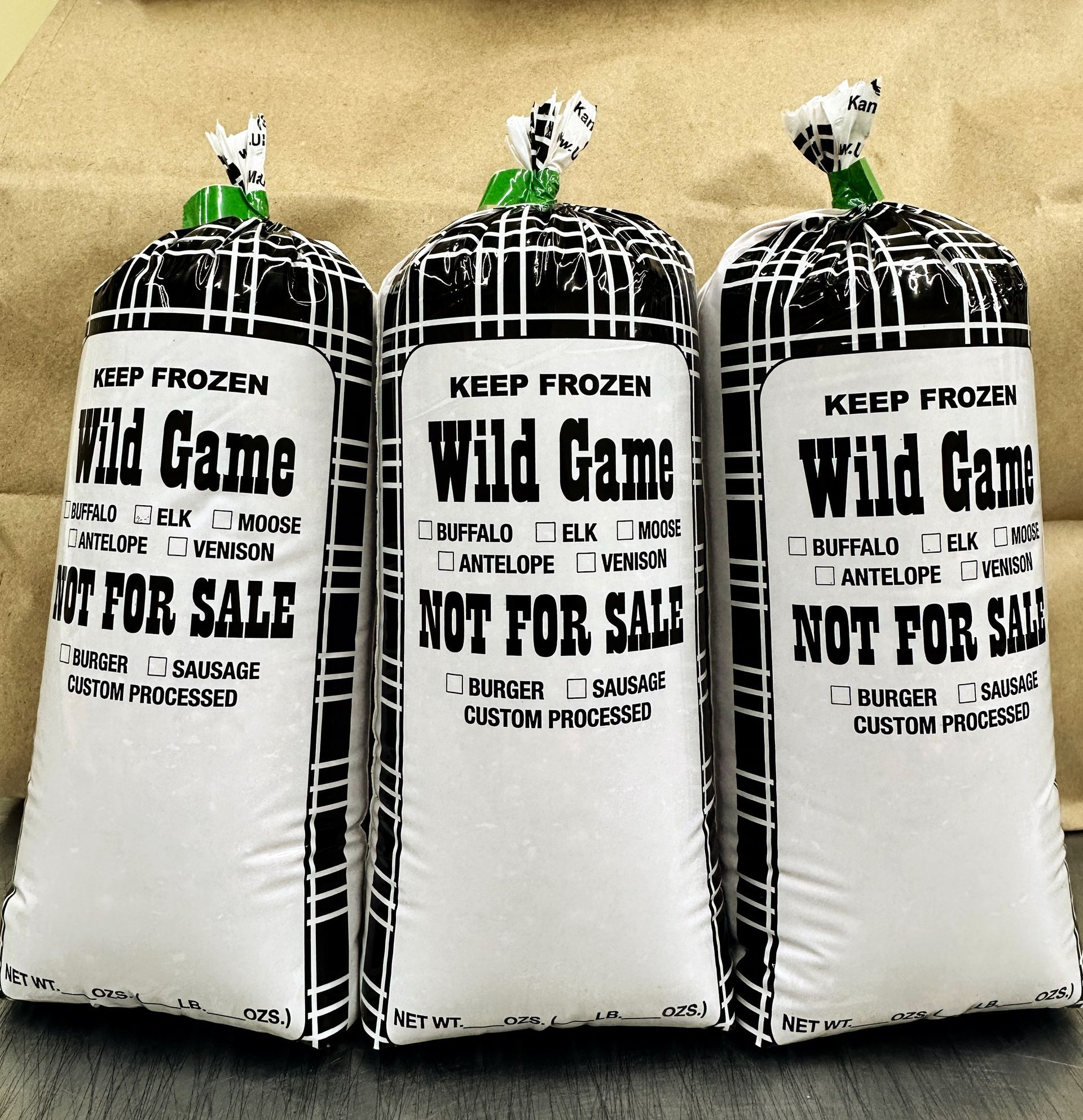 Vacuum-sealed raw meat on a white cutting board, set on a wooden surface.