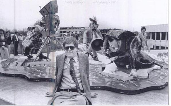 Artist Red Grooms posing in front of his sculpture entitled, “Way Down East”, during installation on Northern Kentucky University campus, with Art Professor and Project Leader, Kevin Booher, back right, 1979.  
