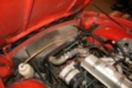 Rusty red car engine—Brake & Transmission Service in Twin Falls, ID