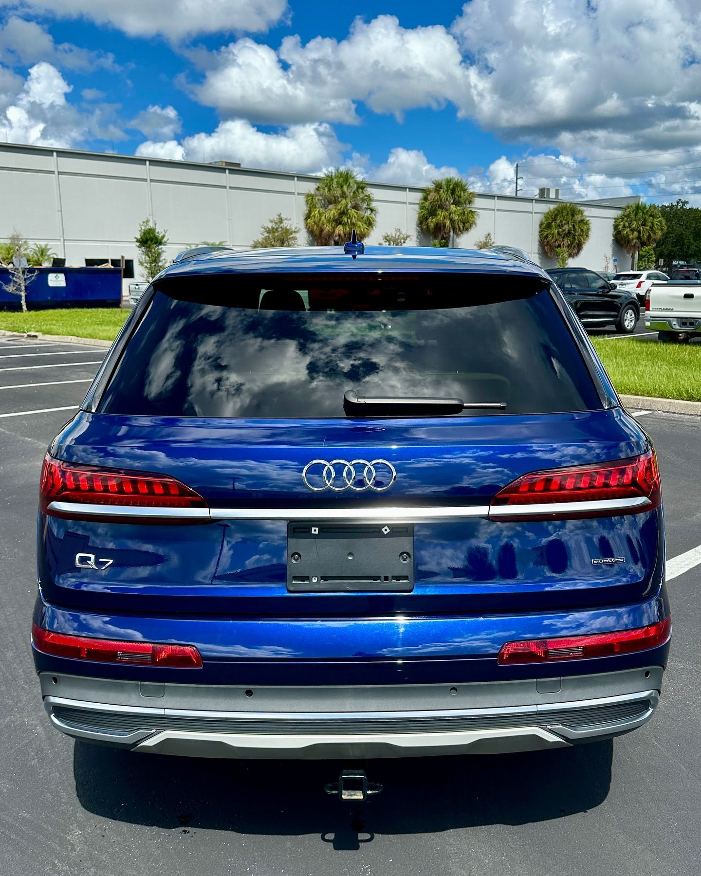 A blue audi q7 is parked in a parking lot