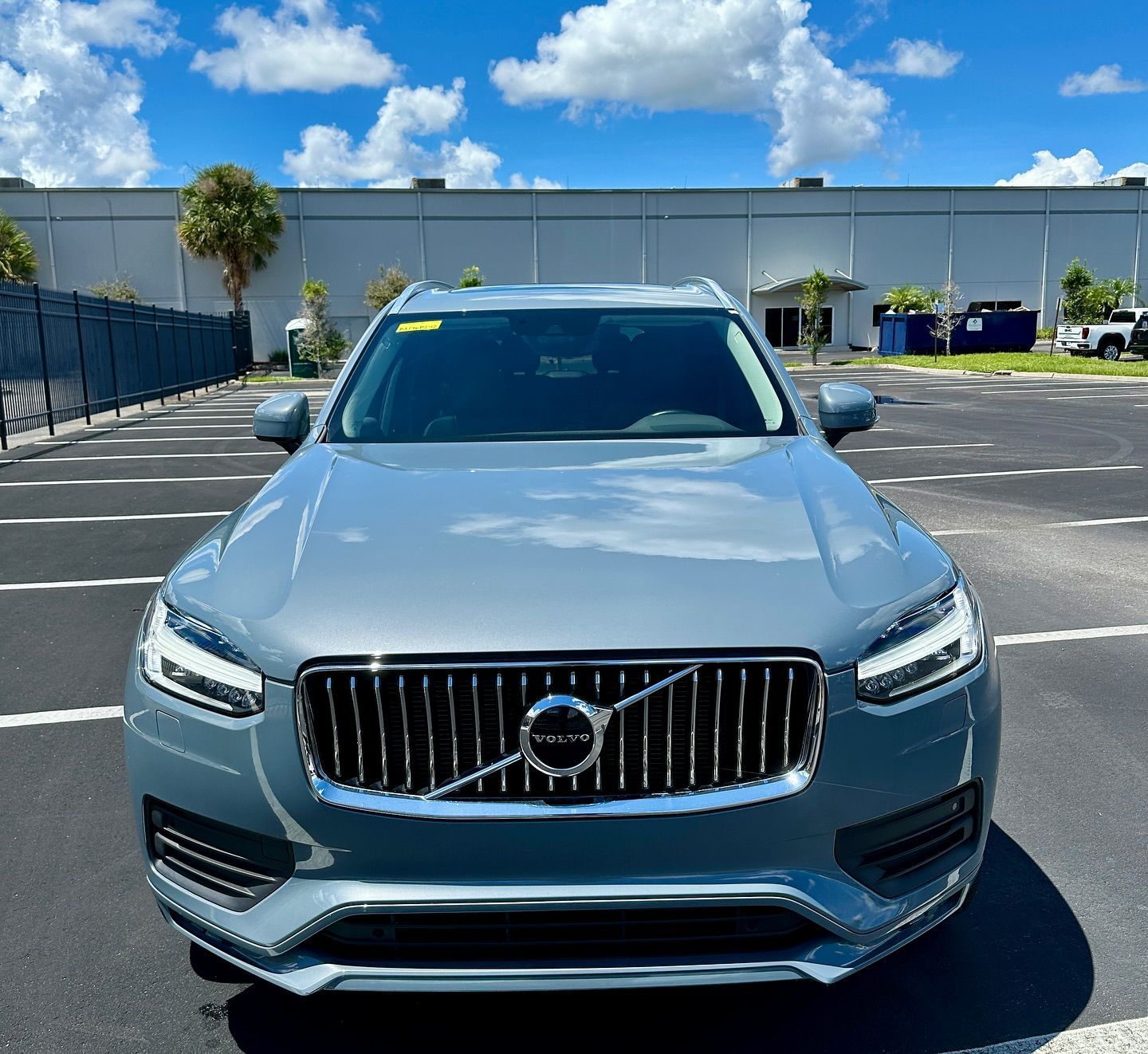 A gray volvo is parked in a parking lot