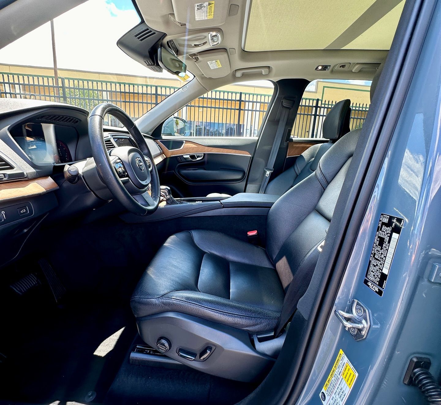 The inside of a blue car with the door open