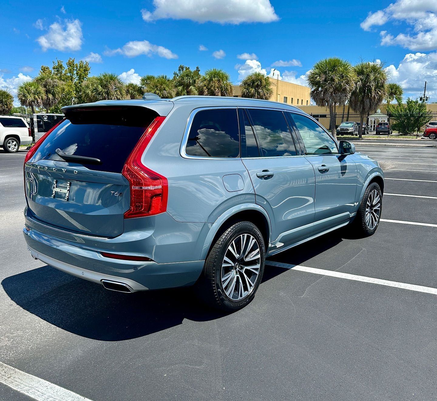 A grey volvo xc90 is parked in a parking lot