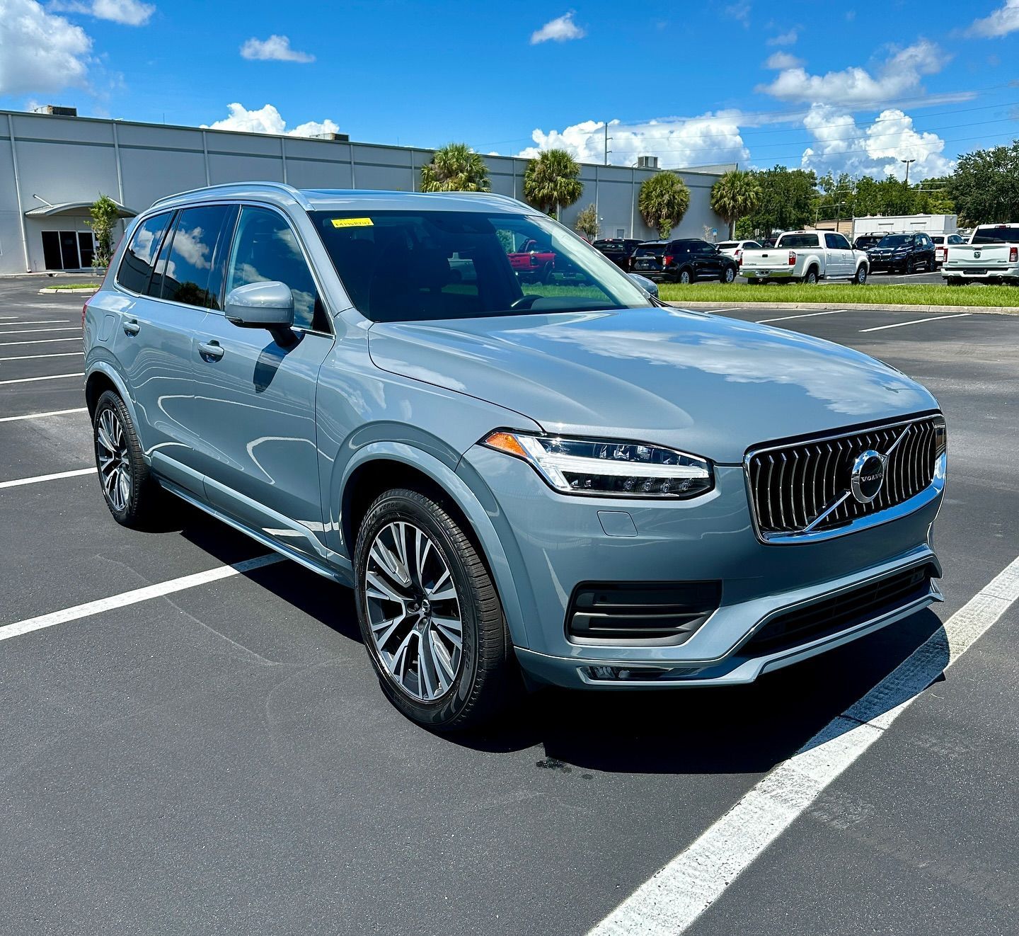 A volvo xc90 is parked in a parking lot.