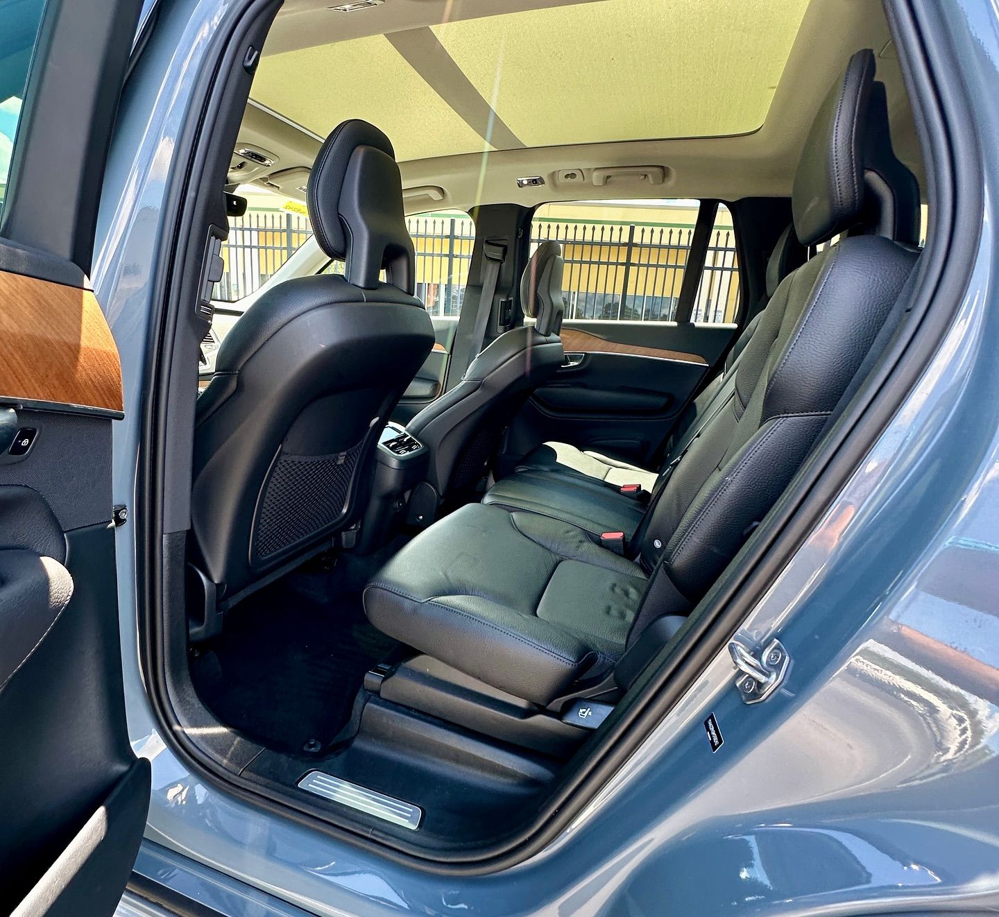 The back seat of a car with the door open