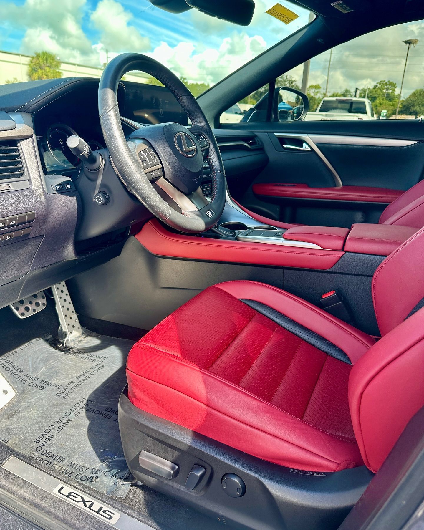 The interior of a lexus rx is shown with red seats and a steering wheel.