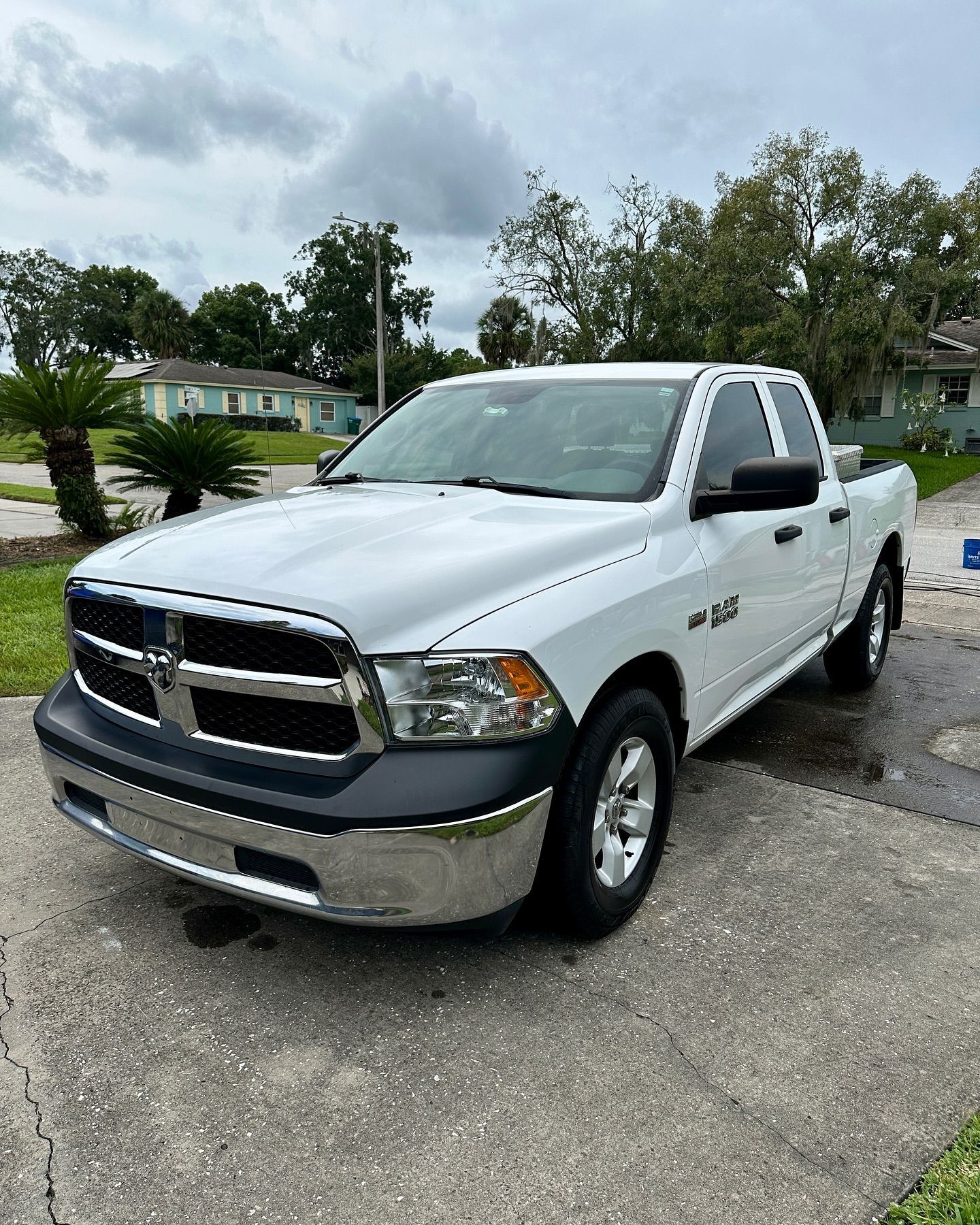 A white dodge ram truck is parked on the side of the road.