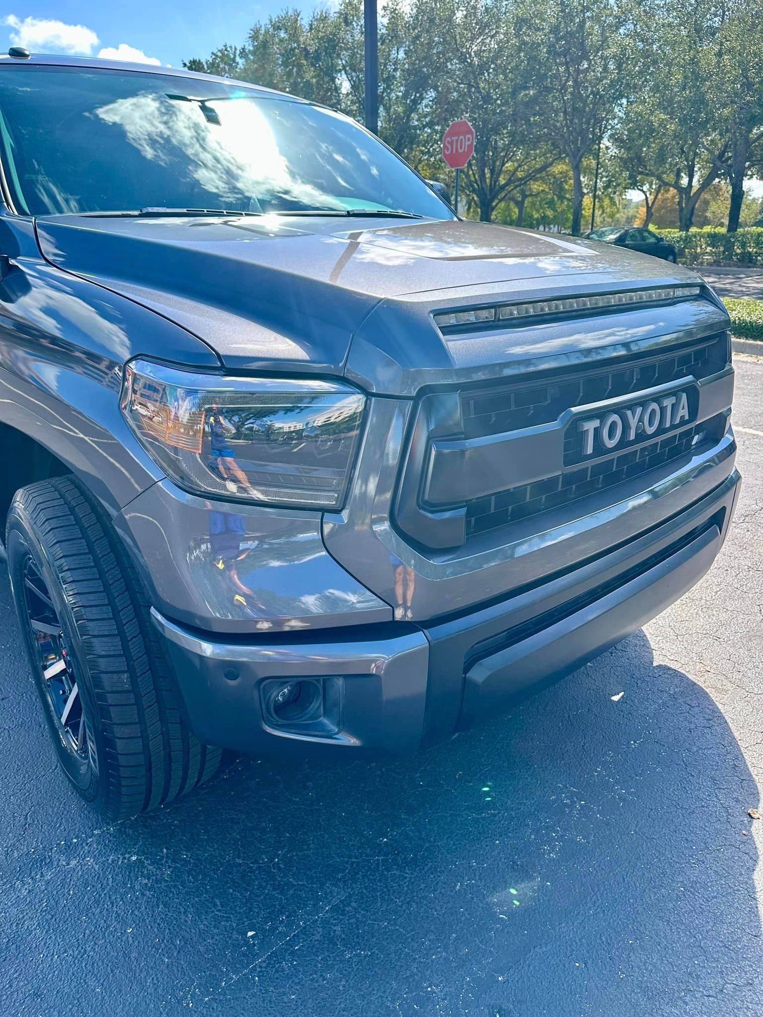 A toyota tundra is parked in a gravel lot.