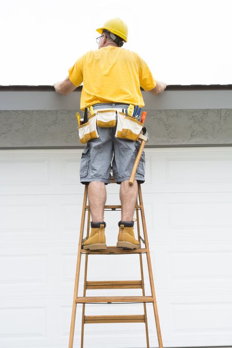 Home Inspection of the Roof - Man on Ladder