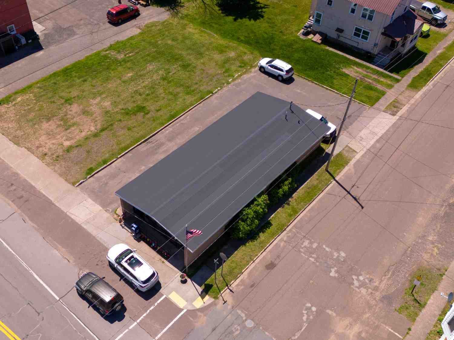 An aerial view of a building with cars parked in front of it