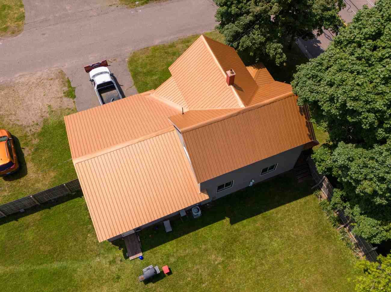 An aerial view of a house with a truck parked in front of it.