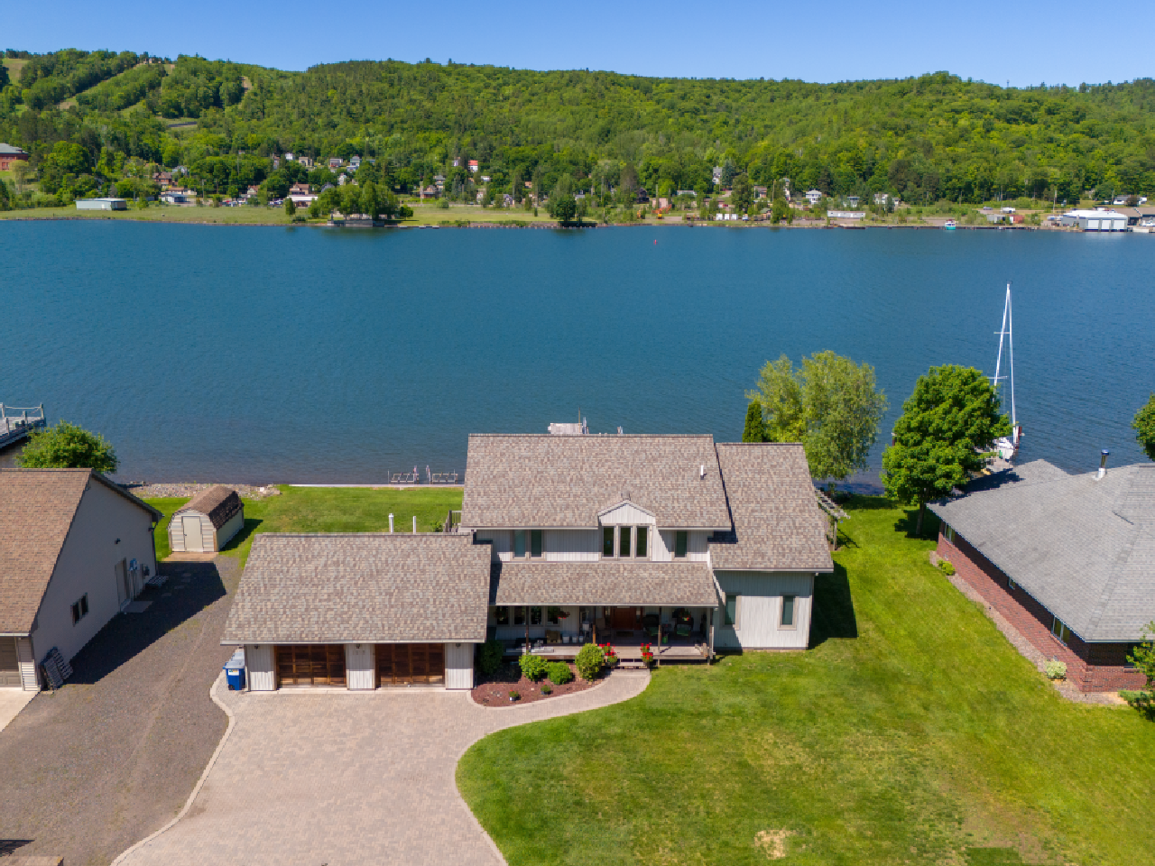 An aerial view of a house next to a body of water.
