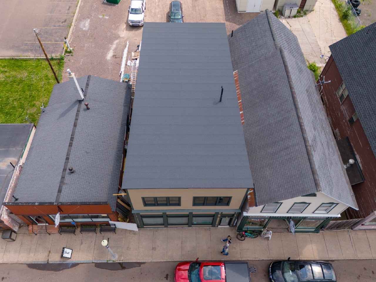 An aerial view of a building with a black roof