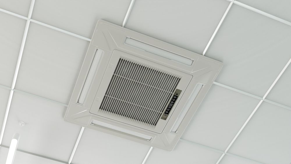 Woman in straw hat smiles, holding wine glass near a lake.