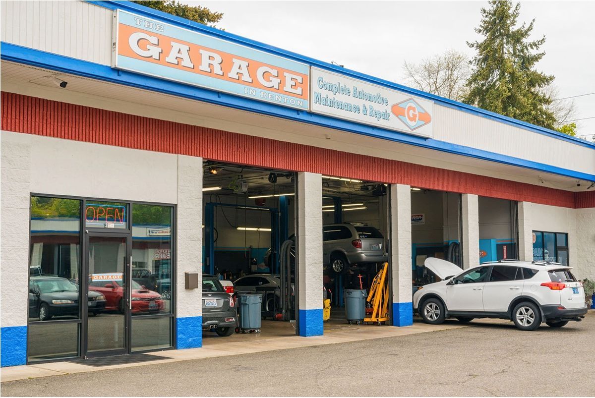 A garage with cars parked in front of it