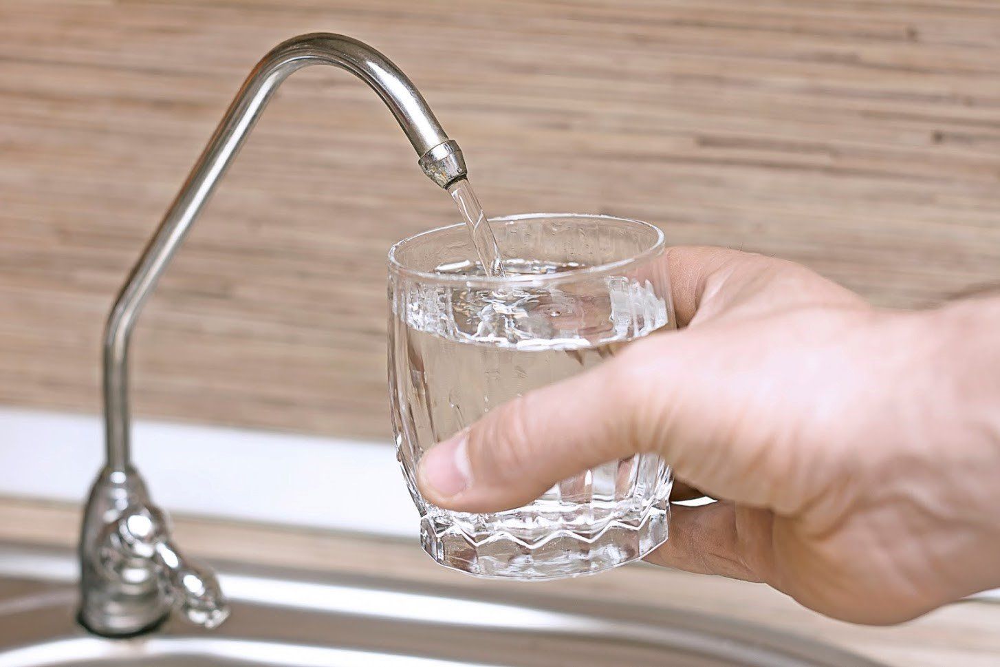 Filling A Glass With Tap Water — Greensboro, NC — Action Well And Pump
