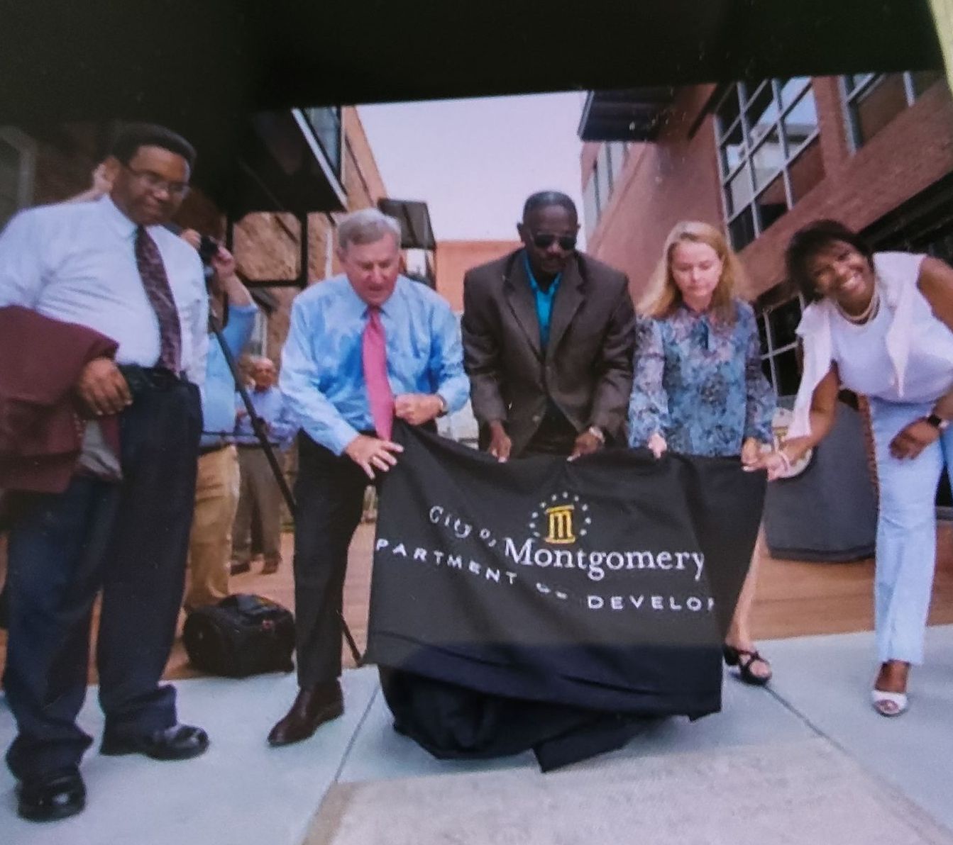 A large obelisk in the middle of a city surrounded by buildings.