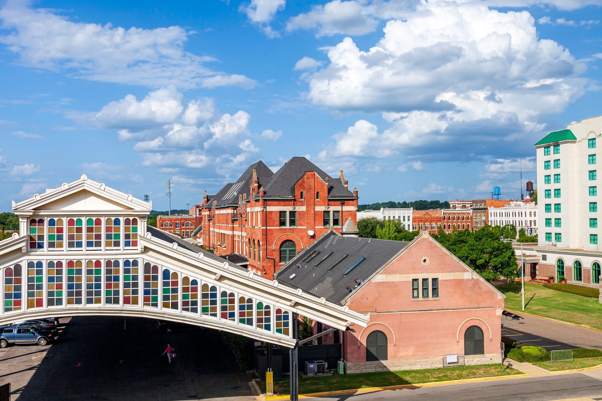 An aerial view of a city with a bridge over a building.