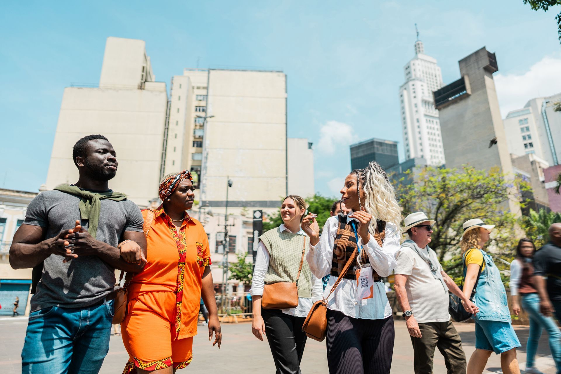 A person is walking down a cobblestone street at night.