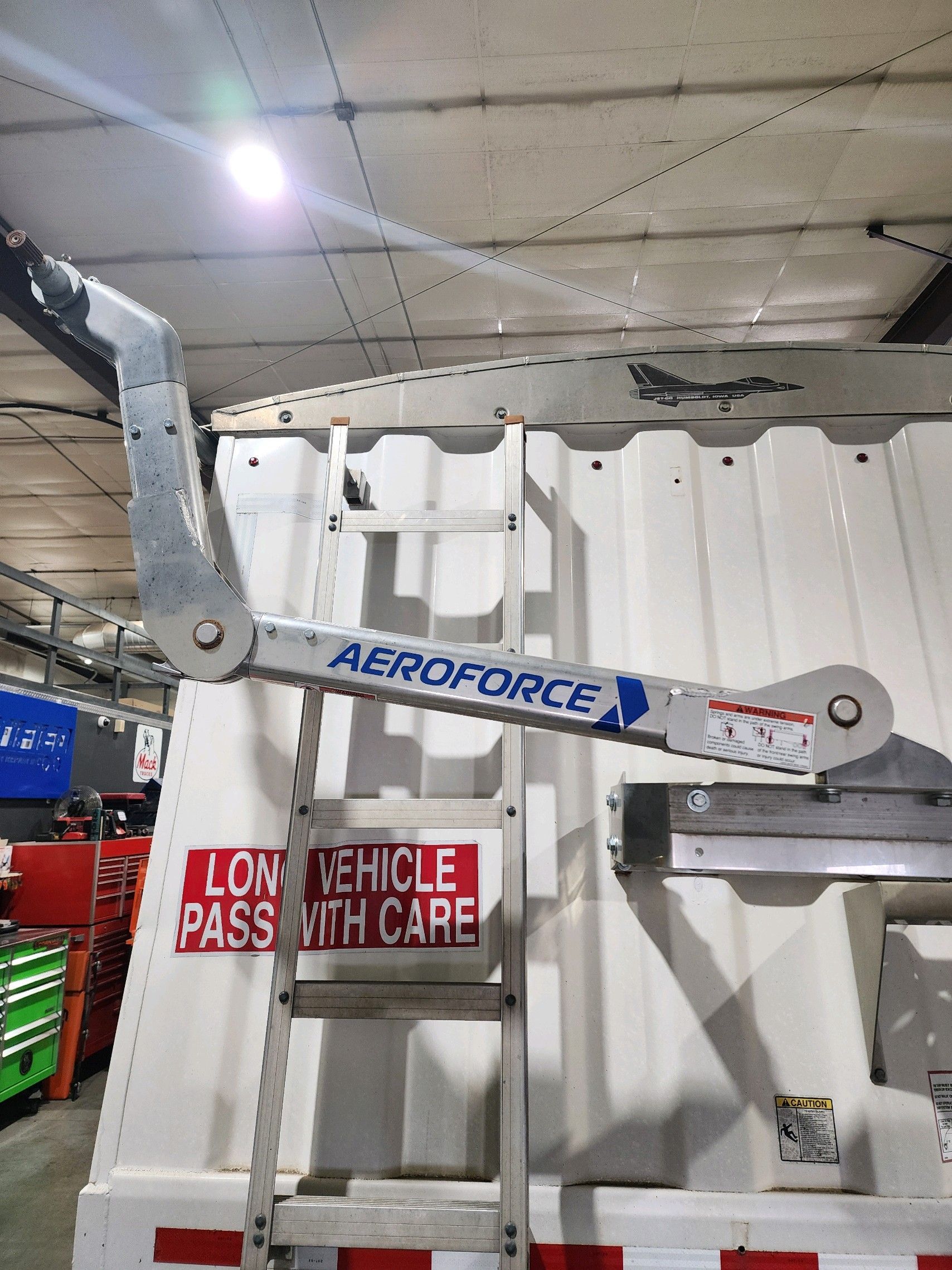 A ladder is attached to the back of an aeroforce vehicle