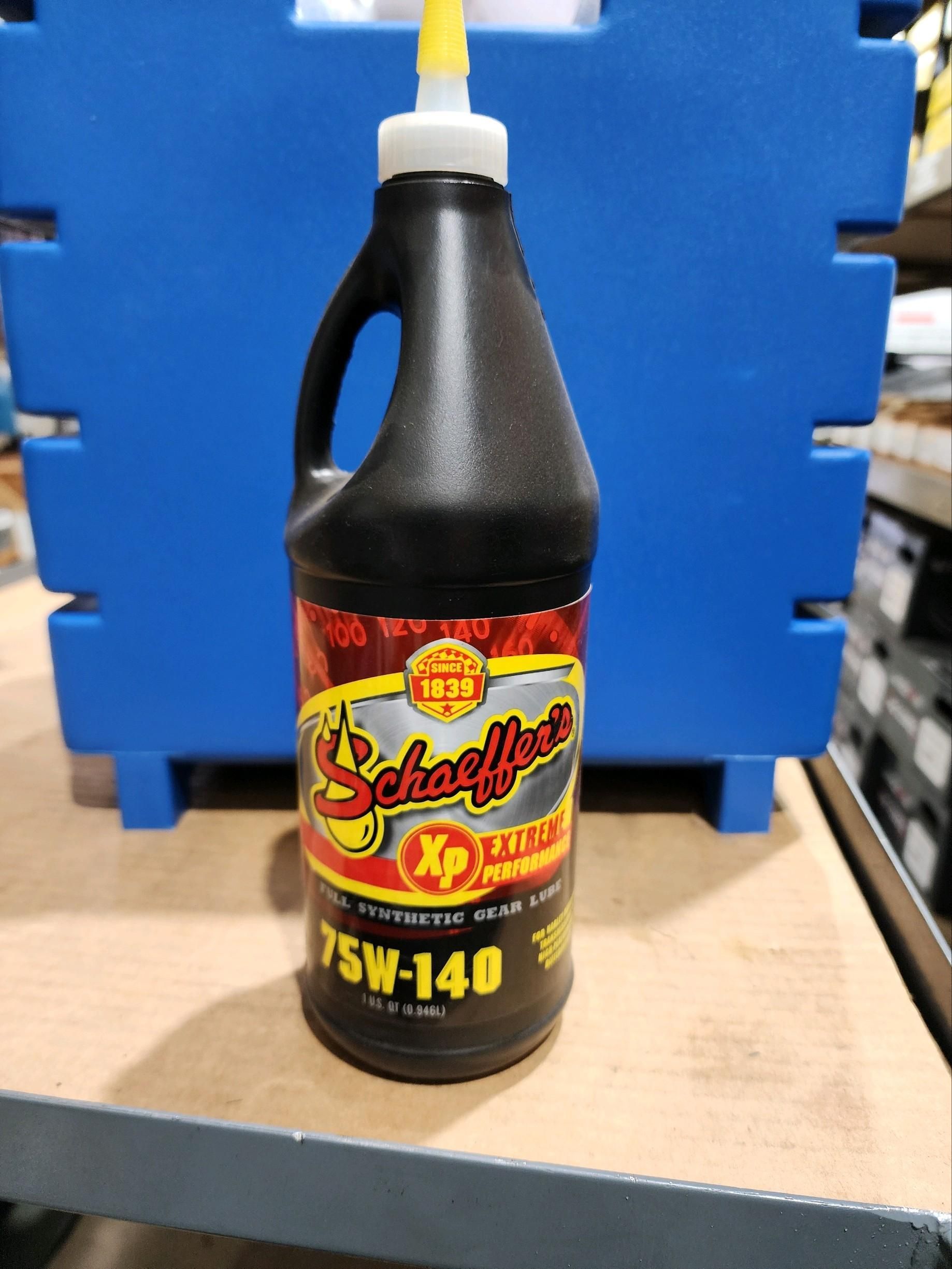 A bottle of 75w-140 is sitting on a wooden table