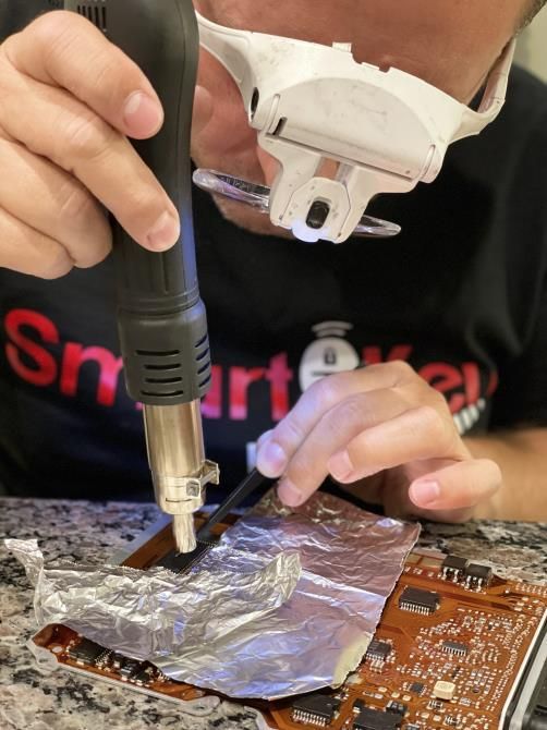 A man is standing in front of a door providing locksmith services