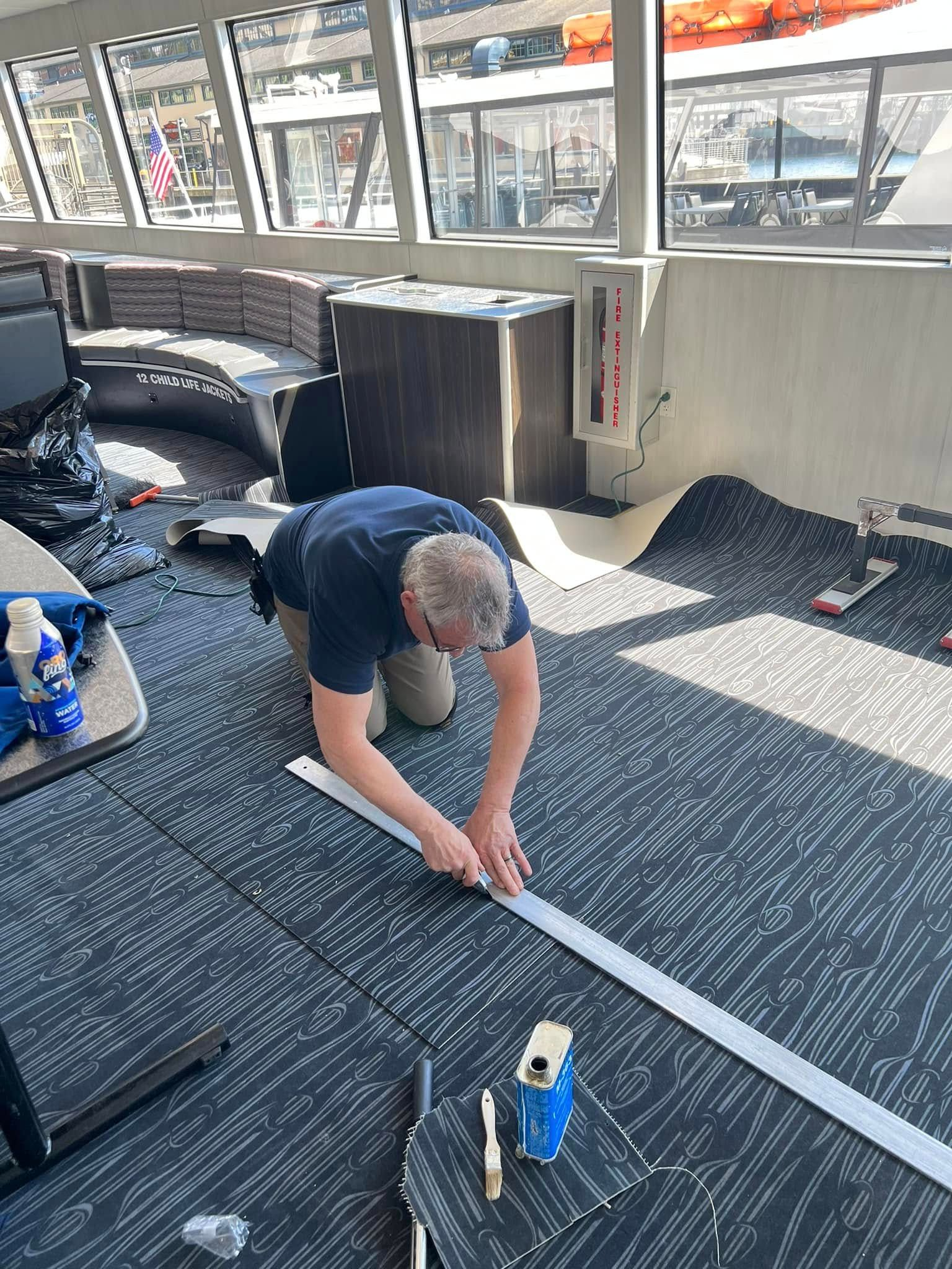 Picture of carpet repair technician repairing a carpet