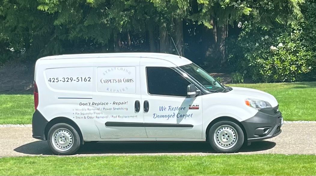 White cargo van parked on a paved road, logo for 
