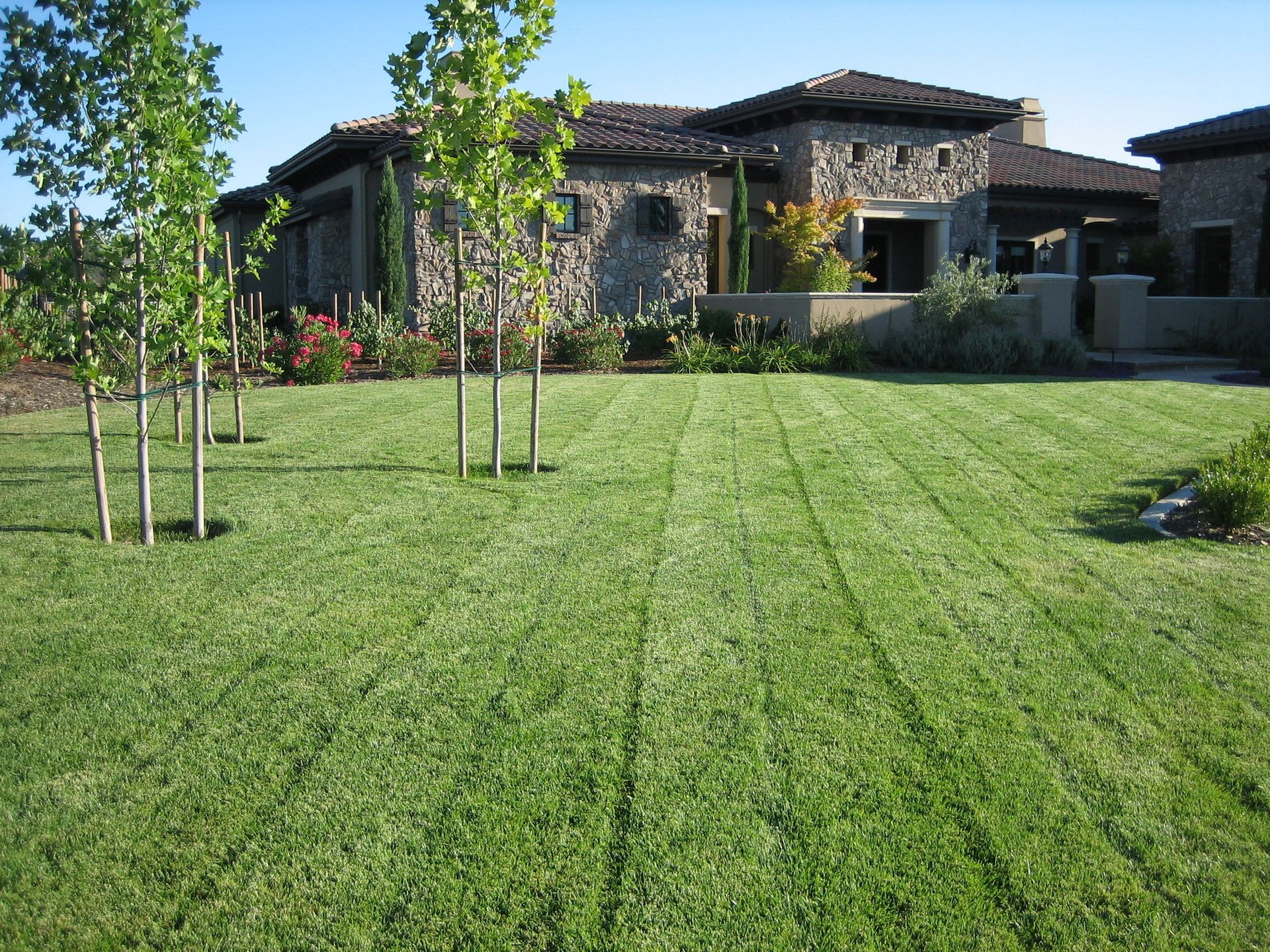 A large house with a lush green lawn in front of it