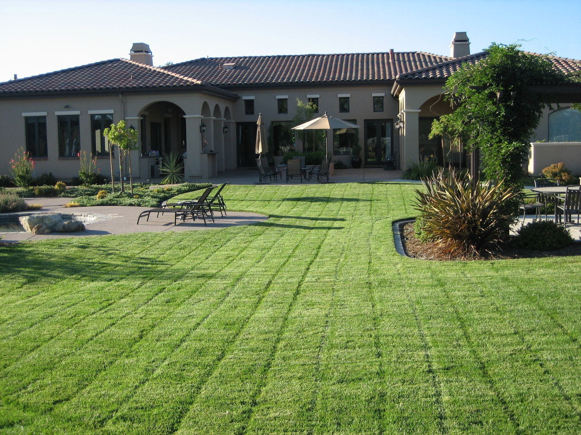 A large house with a lush green lawn in front of it