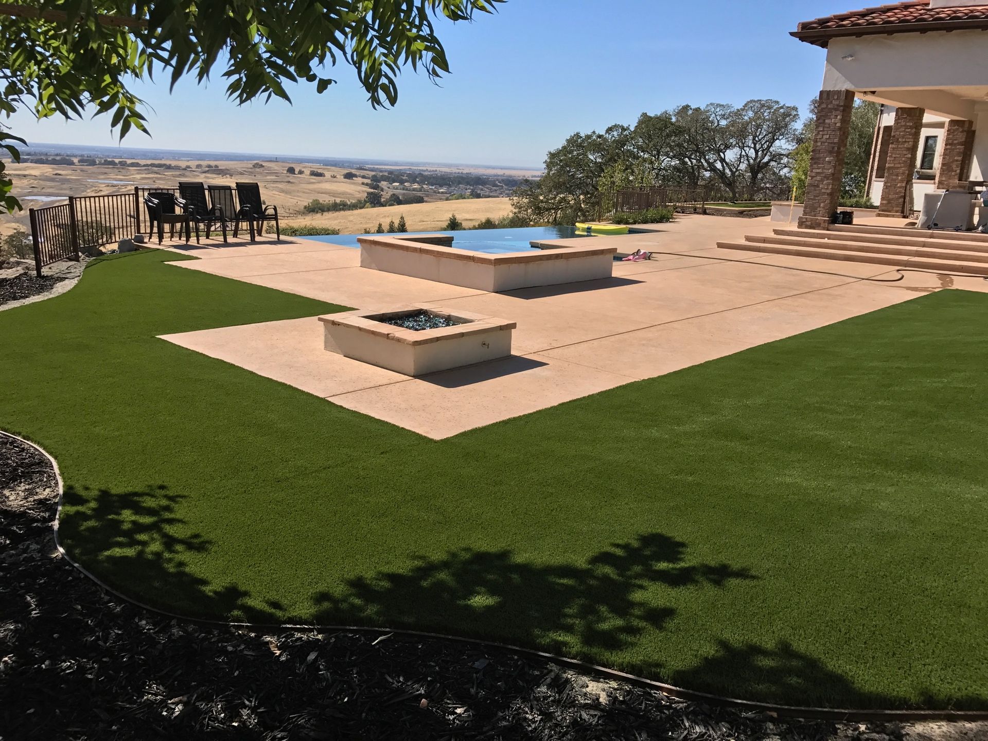 A backyard with a fire pit and a swimming pool