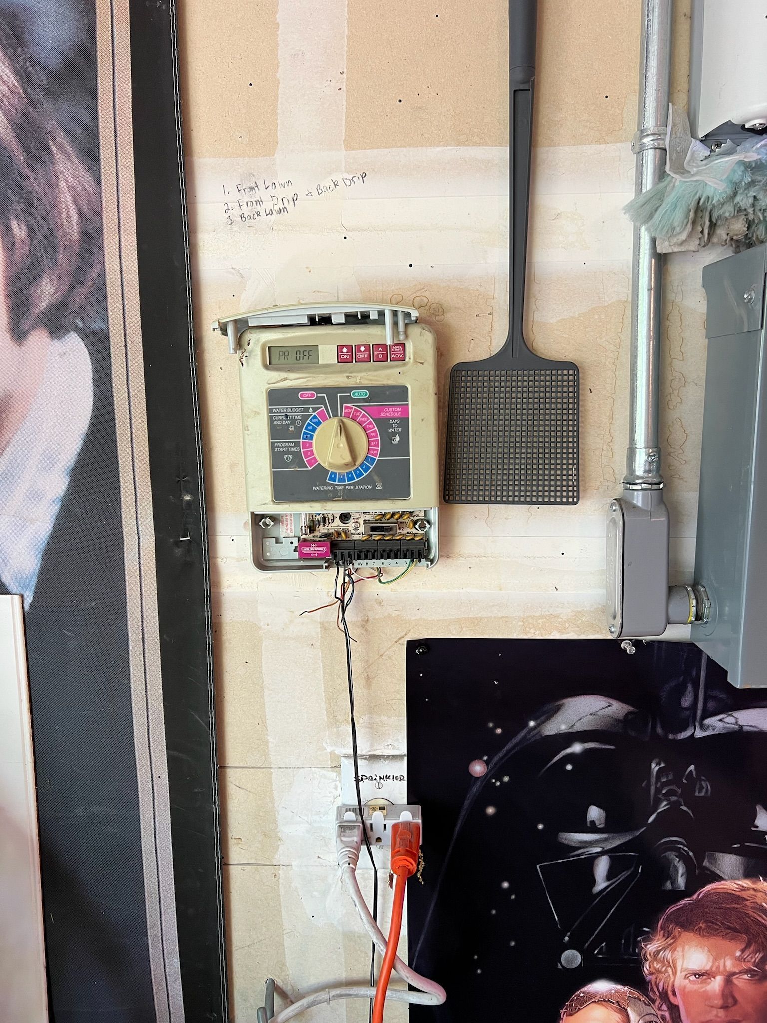 A wall with a clock and a picture of a man on it