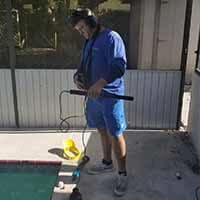 Man checking leak detection —  Pool Maintenance in Spring Hill, FL