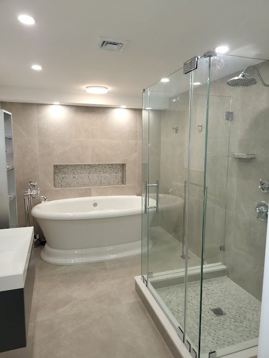 A bathroom with a bathtub and a walk in shower.