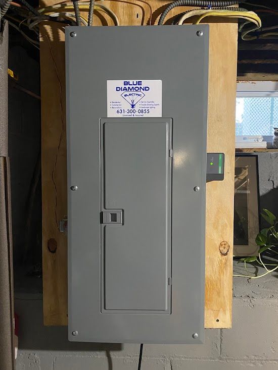 A blue diamond electrical box is hanging on a wall.