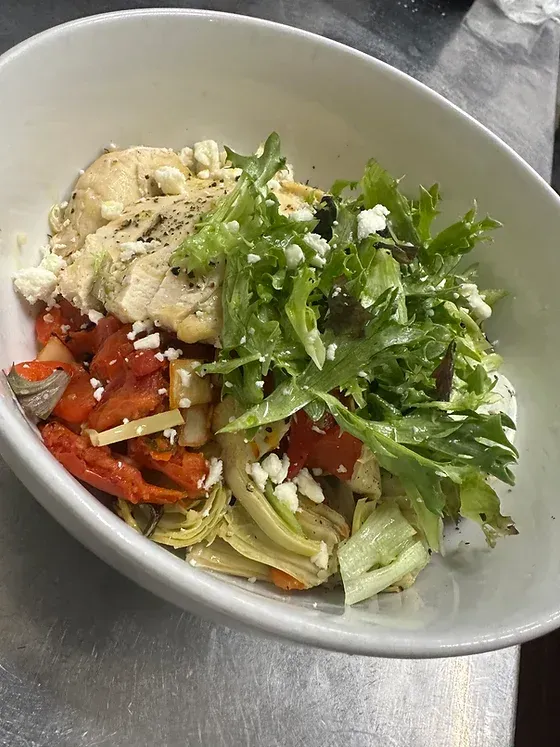 A close up of a bowl of food on a table.
