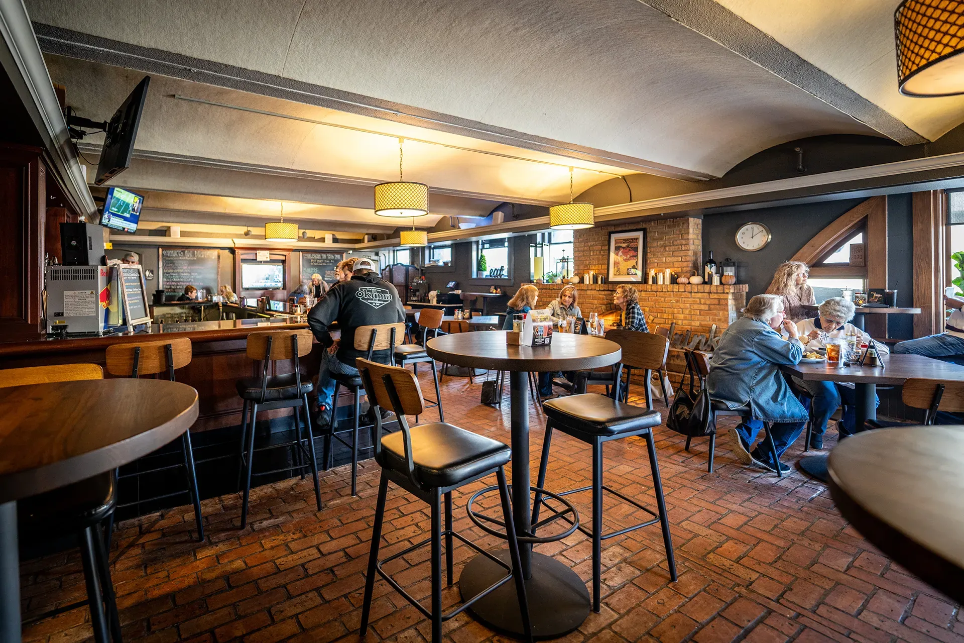 A group of people are sitting at tables in a restaurant.