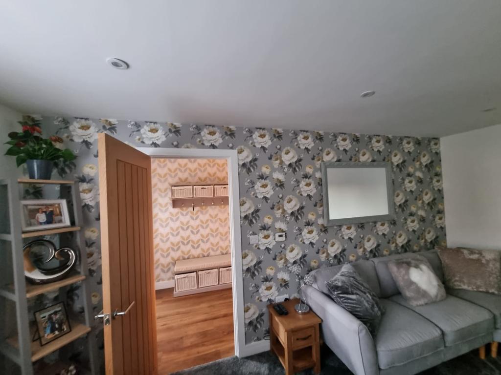 This is a picture of a living room wall that has just been covered in designer wallpaper in a house in Leicester