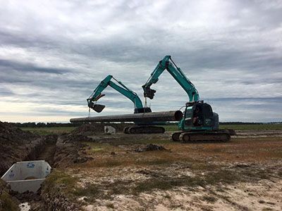 Two excavators are working on a construction site.