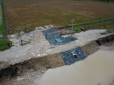 An aerial view of a construction site next to a body of water.