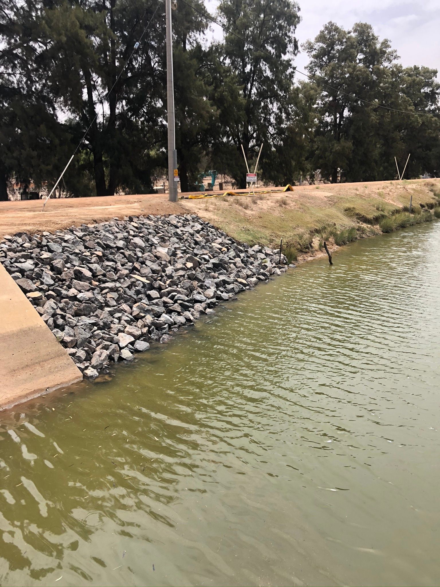 A large body of water surrounded by rocks and trees.