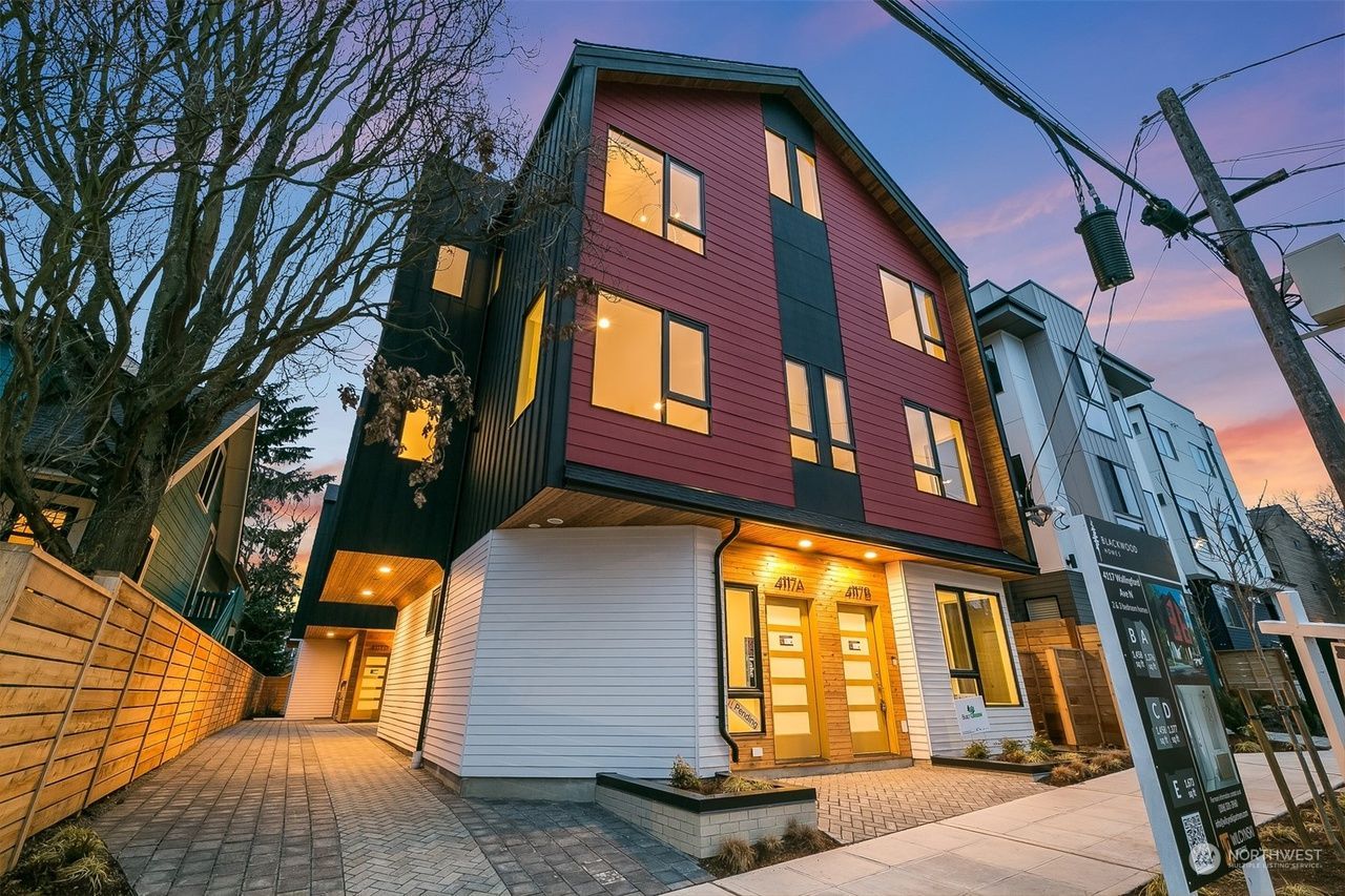 A red and white building with a lot of windows is for sale.