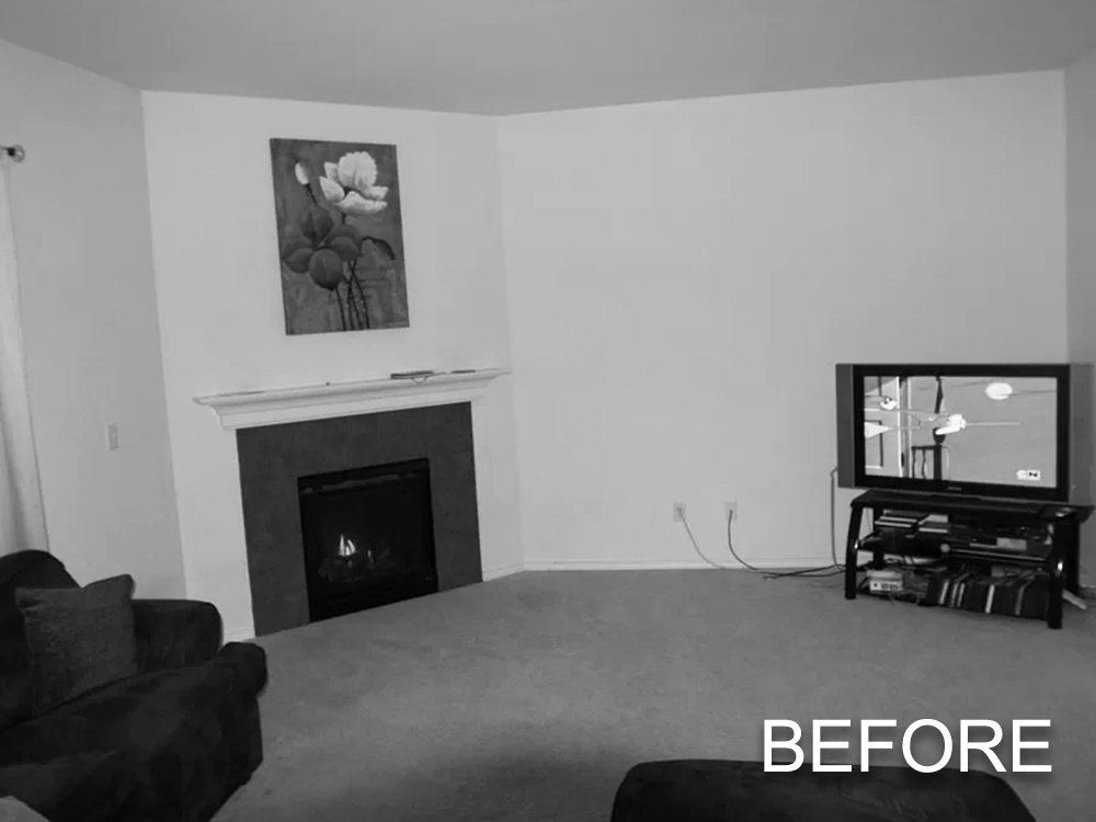 A before picture of a living room with a fireplace