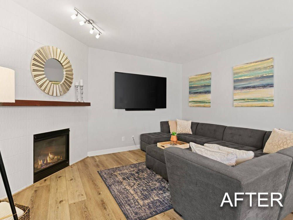 A living room with a couch , fireplace and television.