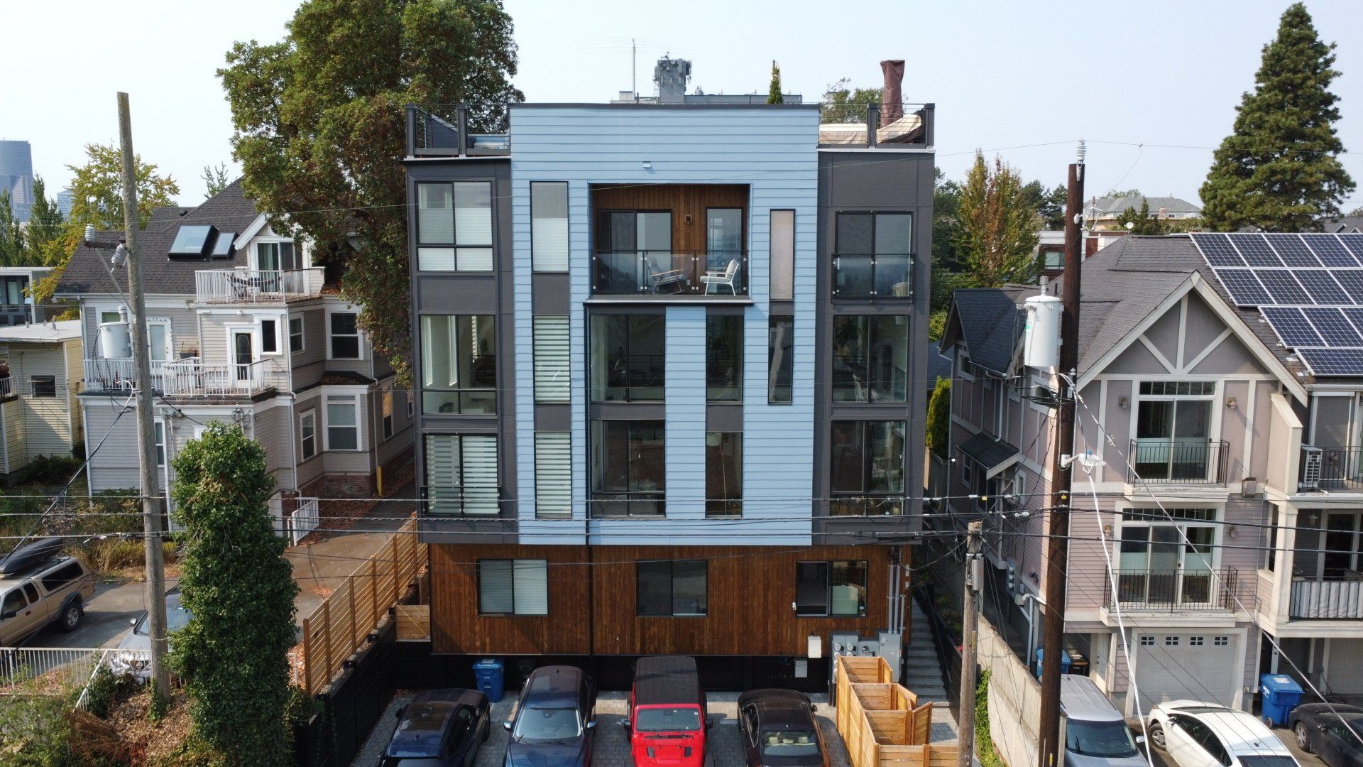 An aerial view of a building with cars parked in front of it.